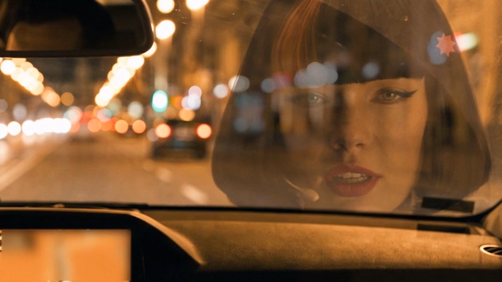 Claudia reflected in a car window at night